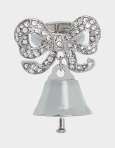 a bell with a bow on it and some crystal beads around the bell is shown