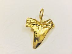 This vermeil shark tooth is a nice piece for necklaces, bracelets and earrings. It measures about 22x15mm including loop. It is 18k gold plated over 925 sterling silver (vermeil), shiny finished. 1 pc. SILVER VERSION: https://www.etsy.com/listing/219670150/925-sterling-silver-oxidized-shark-tooth MATTE VERMEIL VERSION: https://www.etsy.com/listing/242934154/vermeil-18k-gold-over-925-sterling SHINY ROSE GOLD VERSION: https://www.etsy.com/listing/464997918/rose-gold-vermeil-18k-rose-gold-over-925 Gold Arrowhead Jewelry Gift, Gold Arrowhead Jewelry For Gift, Silver Shark, Tooth Charm, Shark Tooth, Shark Teeth, 18k Rose Gold, Gold Vermeil, Necklaces Bracelets