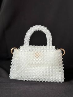 White crystal bag. Clear crystals color. An incredible model for your Wedding or party. The fabric lining - double cotton. Bag with a lining - a perfect choise. Сolored items and cosmetics do not shine through and are not visible through the bag. Bag parameters: - Width (18 cm.) - Height (20 cm.) - Height without handle(12 cm.) Things you can fit in the bag: - Lipstick. - Perfume. - IPhone mini. - Keys. - Cash / Cards White Top Handle Bag For Events, White Beaded Party Bags, White Rectangular Evening Bag With Rhinestones, Luxury White Beaded Bags, Elegant Clear Square Bag, White Rectangular Bag With Rhinestones, White Rectangular Bags With Rhinestones, White Embellished Rectangular Shoulder Bag, White Beaded Evening Shoulder Bag