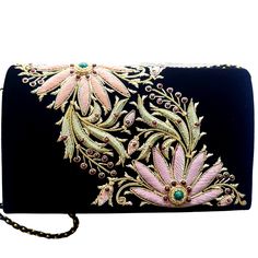 "Luxury black velvet evening bag embroidered with pastel orange and pink flowers and embellished with genuine semi precious stones, to create an opulent, sophisticated 3D effect. So pretty and feminine! Expertly hand embroidered by master zardozi artisans. The word Zardozi means \"gold thread\". It is an elaborate and intricate multidimensional embroidery using metallic threads and genuine semi precious stones. A centuries old technique once reserved for royalty, we now bring it to you. DETAILS: Orange And Pink Flowers, Peacock Clutch, Pink And Orange Flowers, Statement Purse, Crafted Bag, Embellished Clutch, Pastel Orange, Floral Handbags, Floral Clutches