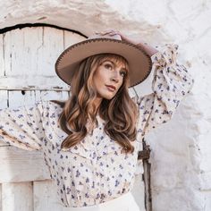 Inspired by the heart of the country scene - Mansfield is a classic pinched crown fedora with western detailing. The stitching detail on the brim , faux leather band with conchos and the statement tear drop shape - this hat is all about walking bold and confident. Features : Brim Size: 3.25" 100% wool Color: Beige Women's one size Wool felt stiff fedora with hand embroidered stitching, faux leather band and western conchos Fitted Fedora For Fall Western-themed Events, Fall Rodeo Felt Hat, Fitted Felt Hat For Rodeo In Fall, Country Style Felt Hat With Flat Brim, Country Style Brimmed Fedora For Ranch, Western Style Wide Brim Felt Hat For Fall, Western Style Brimmed Fedora For Fall, Western Wide Brim Fedora For Fall, Western Brimmed Fedora For Fall