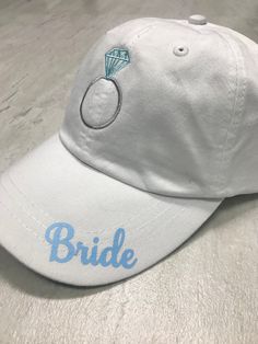 Wedding party hats! *Adams six panel low profile hat *Leather adjustable strap *Embroidered champagne bottle on bridesmaids hat *Embroidered ring on brides hat *printed Wording on rim of Hat *Custom wording is available Contact us with any special request. White Cap Mini Hat For Weddings, Adjustable White Mini Hats For Bachelorette Party, Personalized Adjustable Hats For Wedding, White Adjustable Hat For Bachelorette Party, Personalized White Wedding Hat, White Wedding Hats, One Size Fits Most, White Wedding Hat, One Size Fits Most, White Wedding Hat (one Size Fits Most), White Wedding Hats One Size Fits Most