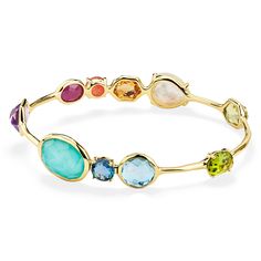 Color is the defining feature of this 18K gold bangle, each stone is deeply hued and hand-faceted to intensify its richness. The prong and bezel-set gems adorning its surface include dark amethyst, rock crystal, mother-of-pearl, lapis, peridot, Swiss blue topaz, and a triplet of mother-of-pearl layered above and below amethyst. Wear it to enhance the vibrancy of any bracelet stack. • 18K Gold • Gemstones: Dark Amethyst, Rock Crystal, Mother-of-Pearl, Lapis, Peridot, Swiss Blue Topaz, Clear Quart Ippolita Jewelry, Amethyst Rock, 18k Gold Bangle, Dark Amethyst, Rainbow Gemstones, Bangles Jewelry Designs, Rock Candy, Jewelry Lookbook, Gold Bangle