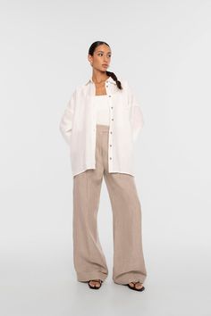 An elevated take. Confidently realized with a pointed collar and dropped shoulders, the Linen Button Down Shirt is finished with shell buttons and extra-wide sleeves plus an inverted pleat detail at the back body. As this shirt features an oversized silhouette, we recommend sizing down if between sizes or a slimmer fit is preferred. Linen Oversized Shirt, Carbon Sequestration, Linen Drawstring Pants, Flax Plant, White Button Up, White Button Down, Shell Buttons, Oversized Silhouette, Wide Sleeves