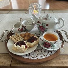 a plate topped with pastries next to a cup of tea