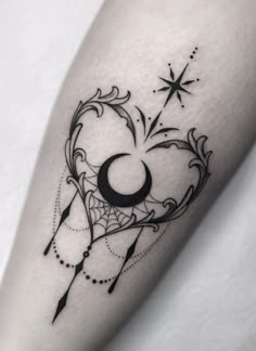 a black and white photo of a tattoo design on the leg, with stars in the background