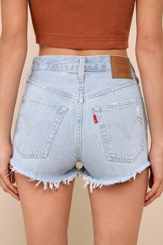 Warm weather is here and it's time to show off those sweet stems in the Levi's 501 Original Light Wash High Rise Cutoff Denim Shorts! Sturdy cotton denim (in Levi's Promise Me wash) shapes these cute shorts with a classic five-pocket cut, belt loops, a branded top button, and a hidden button fly. Subtle whiskering and heavily distressed details lend a lived-in aesthetic! Shredded, cut-off hems complete the look. Red logo tag and leather patch at back. Fit: This garment fits true to size. Length: High Wasted Jean Shorts, Cycling Clothes, Promise Me, Girl Fashion Style, Fashion Bottoms, Denim Cutoff Shorts, Levi's 501, Denim Cutoffs, Logo Tag