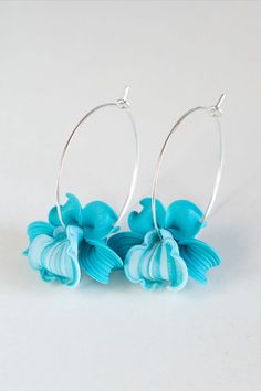 Pair of Hand Sculpted turquoise blue orchid Earrings hoops. Turquoise Flower in Hoops Earrings. Turquoise Flower Earrings As A Gift, Gift Turquoise Flower Earrings, Turquoise Flower Charm Earrings For Gift, Gift Turquoise Flower Charm Earrings, Turquoise Dangle Earrings With Flower Charm, Blue Handmade Flower Drop Earrings, Turquoise Nickel Free Flower Earrings, Nickel Free Turquoise Flower Earrings, Turquoise Flower-shaped Earrings With Flower Charm