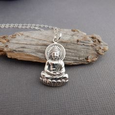 sterling silver Buddha necklace, 1" Gautama Buddha....a sage, leader, and teacher whose life serves as the foundation of the Buddhist religion. - A solid sterling silver Buddha pendant, 1" (2.5 cm) in height, just over 1/2" (16 mm) across at widest point.  - Necklace is 1.5 mm cable chain, with lobster clasp and locking jump rings, all solid sterling silver. - The front is a very detailed relief, oxidized (blackened) to bring out the detail. The back is smoother and flat, hollowed out in some parts, with tiny 925 mark.  - With sustainability in mind, charm is made from 100% post-consumer recycled sterling silver. - A great length to layer with other necklaces. - Packaged in a modern circular tin, ready for gift giving, and comes with a silver polish pad and care instructions. Customize cha Silver Round Pendant Necklace For Meditation, Spiritual Sterling Silver Charm Necklaces In Silver, Spiritual Silver Charm Necklace Nickel Free, Spiritual Sterling Silver Charm Necklace In Silver, Spiritual Sterling Silver Nickel Free Charm Necklace, Spiritual Sterling Silver Charm Necklace With Round Pendant, Spiritual Sterling Silver Nickel-free Charm Necklace, Sterling Silver Engraved Necklaces For Meditation, Sterling Silver Engraved Charm Necklace For Meditation