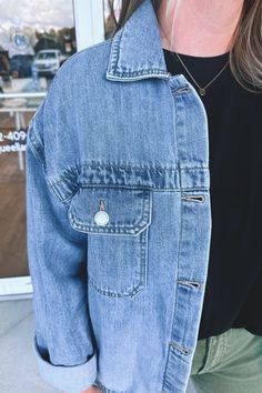 Oversized, denim, trucker jacket. This boxy silhouette is perfect for layering and legging styles. Silver metal buttons line the front and are featured on the pockets. Traditional and timeless collared neckline and yoke across the back. Light/medium wash jean material that is slightly weighted but soft and stretchy. We recommend sizing down if you're traditionally between sizes. - 100% cotton Trendy Everyday Denim Jacket, Trendy Everyday Denim Jacket With Pockets, Light Wash Button-up Denim Jacket, Light Wash Collared Denim Jacket With Pockets, Trendy Medium Wash Denim Top With Pockets, Trendy Denim Jacket With Buttoned Pockets, Trendy Collared Light Wash Denim Jacket, Everyday Light Wash Denim Jacket With Buttoned Pockets, Trendy Denim Blue Jacket With Buttoned Pockets