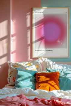 a bed with pink and blue sheets in a bedroom next to a painting on the wall