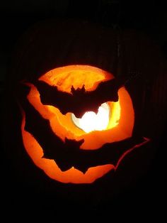 a carved pumpkin with bats on it