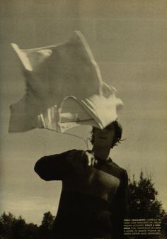 a man holding a white cloth over his head