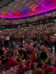 many people are laying on the floor in an arena