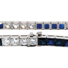 This wonderful vintage piece features 9.80ctw of vibrant blue sapphires combined with 5.30ctw of sparkling round brilliant cut diamonds. The diamonds are graded G-H in color and VS1-2 in clarity and form a beautifully dramatic contrast to the deep blue sapphires. A stunning Mid Century era treasure set in platinum, this bracelet fastens securely with a push style clasp, and has a hidden safety latch. This bracelet measures 7.25 inches long. It has been independently appraised at a value of $25,0 Classic Sapphire Tennis Bracelet With Brilliant Cut, Timeless Blue Diamond Bracelet, Luxury Blue Diamond Bracelet, Classic Sapphire Gemstone Tennis Bracelet, Luxury Sapphire Tennis Bracelet With Brilliant Cut, Classic Sapphire Bracelet With Prong Setting, Classic Diamond Bracelet With Sapphire, Classic Sapphire Diamond Tennis Bracelet, Classic Sapphire Tennis Bracelet With Prong Setting