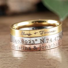 two wedding bands with names engraved on them