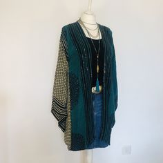 "A Stunning Sequinned Boho Kimono Jacket. Loose and floaty; Silk and sequinned;a Perfect cover up for Holidays,Festivals and Evening Parties. This is Handmade from a Vintage Indian Sari. so completely Unique and Sustainable. A Wonderfully Chic and Flattering Jacket in Teal , back and ecru ,Beautifully embellished allover with Sparkling Sequins, the style drapes elegantly , and has wide Kimono sleeves. Will fit and flatter sizes  S M L UK 8 to 14  . US 4 to 10 . European 36 to 42.  The mid length is 90 cm / 35 \". The chest is 88cm / 36 \" . Timeless and elegant Boho Chic ! To see more unique designs like this please visit my Etsy Boutique at: https://www.etsy.com/shop/BohoStarIbiza" Bohemian Long Sleeve Cardigan For Party, Bohemian Sequined Festive Outerwear, Festive Bohemian Sequin Outerwear, Blue Embellished Bohemian Outerwear, Green Bohemian Open Front Top, Etsy Boutique, Black Kimono, Embellished Jacket, Kimono Sleeves