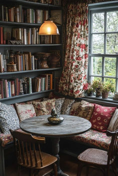 a room with bookshelves full of books and a round table in the corner