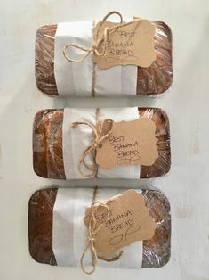 three packages of bread wrapped in plastic and tied with twine on top of each other