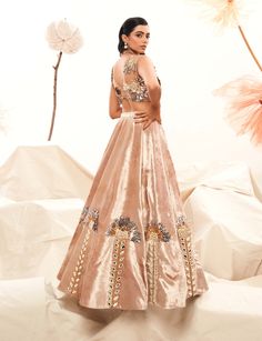 This champagne velvet lehenga is a regal masterpiece, adorned with 3d leaf-shaped sequins, pearls, mirror work, glass beads, and metallic stripes. Paired with a matching organza blouse, this ensemble exudes opulence and sophistication, perfect for a statement look. Lehenga And Blouse, Velvet Lehenga, Organza Blouse, Mirror Work, Lehenga, Glass Beads, Champagne, Stripes, Velvet