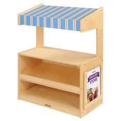 a wooden toy store shelf with blue and white striped awning over it's top