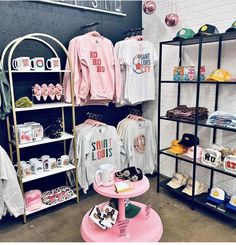 a clothing store filled with t - shirts and hats