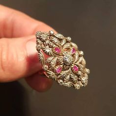 "RING SIZE: 7.5 US 56 EU GOLD: 14 ct. WEIGHT: 11.70 grams SIZE: 35 mm x 23 mm RUBIES: authentic, 0.35 ct. DIAMONDS TOTAL WEIGHT: 0.40 ct CUT: pink cut, in the center is an old European diamond COLOUR: K CLARITY: Si2 CONDITION: EXCELLENT Stunning Art Deco style diamond and ruby ring with a beautiful floral design. The ring features 14 carat gold Hungarian \"fox heads\" from 1867 to 1922. Rose cut diamonds and one old european cut Si2 clarity and K color total 0.40 ct and uncut, genuine rubies 0.3 Victorian 14k Gold Diamond Cut Rings, Antique Gold Ring With Rose Cut Diamonds, Gold Ruby Rings With Intricate Design, Gold Ruby Ring With 17 Jewels For Wedding, Gold Ruby Ring With Intricate Design, Fine Jewelry Gold Ruby Ring With Intricate Design, Fine Jewelry Yellow Gold Ruby Ring With Intricate Design, Gold Ruby Ring With Rose Cut Diamonds, Fine Jewelry, Gold Ruby Ring With 17 Jewels For Anniversary