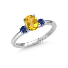 an oval yellow sapphire and blue sapphire ring on a white background with the diamond in the center