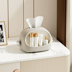 a white counter top with some candles on it and a picture frame next to it