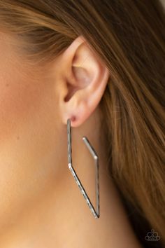 a woman wearing large gold hoop earrings on her left ear and the other side of her ear