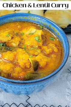 chicken and lentil curry in a blue bowl on a white tablecloth with text overlay