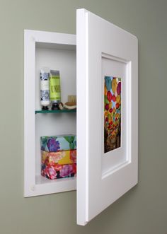 an open white shelf with various items on it