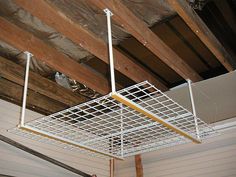 a metal shelf suspended from the ceiling in a room