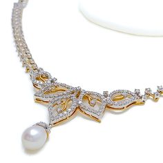 This exquisite 18k gold set, weighing 23.9 grams, features a graceful design adorned with dazzling diamonds and elegant pearls. The combination of yellow and white gold enhances its luxurious appeal, making it perfect for any special occasion. The set includes a necklace with a total diamond weight of 2.86 carats, featuring F-G color and VS quality diamonds in round brilliant cut shapes. The pearls are elegantly shaped in drops, adding a touch of sophistication. The necklace has a length of 16.2 Exquisite Yellow Gold Necklace With Pearl Drop, Yellow Gold Pearl Necklace With Diamond Accents As Gift, Exquisite Diamond Necklaces With Pearl Drop, Luxury Yellow Gold Pearl Necklace With Diamond Accents, Luxury Drop-shaped Pearl Necklace, Lock Style, Diamond Set, Quality Diamonds, Gold Set