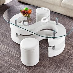 a modern coffee table with two stools and a glass top