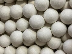 white balls are stacked up in a pile