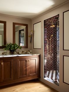 a bathroom with two sinks and a tiled shower stall in the middle of the room