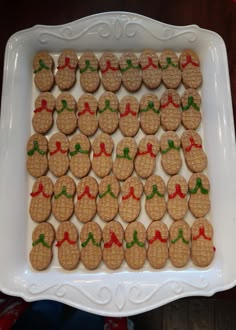 some cookies are arranged in the shape of mickey mouses on a white platter