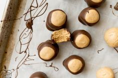 chocolate covered cookies and peanut butter balls on a baking sheet, ready to be eaten