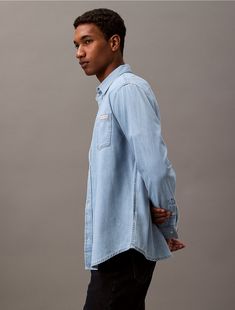 Crafted completely from cotton denim, this button-down shirt has a classic silhouette. Made with button closures along the front and finished with topstitching details.  Material: 100% Cotton. Denim Button Down, Classic Silhouette, Button Downs, Calvin Klein, Button Down Shirt, Quick Saves