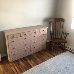 a bedroom with a dresser and chair in it