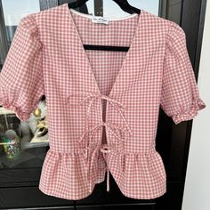 New Pink Gingham Tie-Front Top From Miss Selfridge. - Size Small - Three Ties In The Front - Puff Sleeves With Elastic - Mini Peplum Hem - Cute White Trim Never Worn But Missing The Tags Spring Gingham V-neck Blouse, Gingham V-neck Blouse For Summer, Spring Gingham V-neck Top, Gingham V-neck Tops For Spring, Gingham Short Sleeve Top For Brunch, Short Sleeve Gingham Tops For Brunch, Spring Gingham Blouse For Picnics, Spring Gingham Blouse For Picnic, Preppy Gingham Tops For Spring