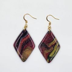 These handcrafted Marbleized Earrings will add something new and exciting to your jewelry collection! Each earring dangles 2.5" from a 18K gold hanger accented with a glistening gold features. Materials: 18K gold & resin Features: 2.5" drop, 1.125" at widest diameter, Lead & Nickel free  DISCLAIMER: The colors and/or patterns of received items may differ from what is pictured. Unique Gold Teardrop Earrings Gift, Unique Gold Earrings With Lever Back Ear Wires, Gold Teardrop Danglers For Gift, Gold Teardrop Danglers As A Gift, Unique Gold Drop Danglers, Gold Hangers, Etsy Earrings Dangle, May 21, Something New