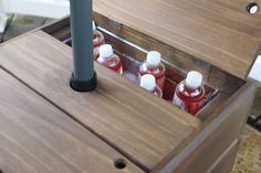 an open wooden box with several bottles in it