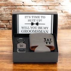 the groomsmen gift set includes a leather wallet, tie and keychain