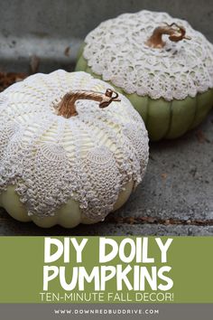 two white pumpkins with doily on them sitting on the ground next to each other