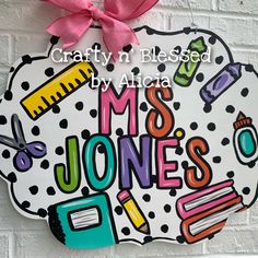 "All our door hangers are designed and hand painted by me! They can be completely customized to YOU! Colors and wording can be changed.  MEASUREMENTS: 22\" WIDE They are hand painted on 1/2\" plywood with acrylic paint and sealed with a clear gloss. Ribbon may vary depending on availability. These are NOT ready to ship/pickup, they are all made to order and you can see our current turnaround time on our main shop announcement page.  We also offer free local pickups. For Georgetown, KY Pickup whe Teacher Plaques Signs, Door Hangers Diy Easy, Door Hangers For Teachers, Classroom Door Hangers, Painted Clipboards, Funky Letters, Painted Door Hangers, Georgetown Ky, Classroom Door Sign