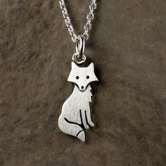 "This sweet little fox is made of sterling silver. The pendant is quite TINY, measuring about 3/4\" (2 cm) from the tip of the ears to the tip of the tail.  So cute! You can purchase just the pendant/charm, or complete the necklace with a sterling silver chain.  For the matching fox earrings:  https://www.etsy.com/listing/188322134/tiny-fox-earrings © Stick Man Creations This is our own original design, handcrafted by us, and signed on the back with our logo.   For more information about the creative process, click here:  www.etsy.com/shop/StickManJewelry/about CANADIAN ORDERS:  Please note that GST and HST are included in the price, but provincial taxes are not." Cute Silver Sterling Silver Charm Necklaces, Cute Sterling Silver Pendant Charm Necklace, Cute Sterling Silver Pendant Charm Necklaces, Cute Nickel-free Sterling Silver Necklaces, Cute Silver Charm Necklaces, Whimsical Silver Dangle Charm Necklaces, Cute Silver Pendant Charm Necklace, Cute Handmade Sterling Silver Necklaces, Handmade Cute Sterling Silver Charm Necklaces