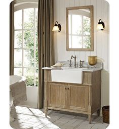 a bathroom sink sitting under a mirror next to a window