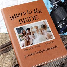 a brown book sitting on top of a table next to a pair of binoculars and other items